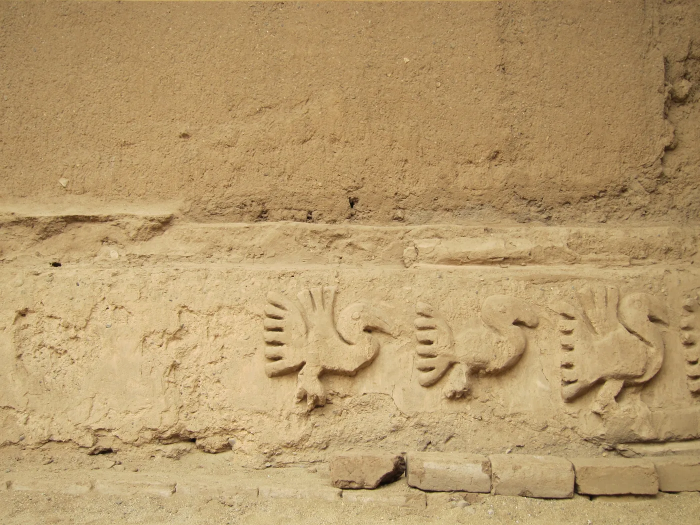Adobe relief of seabirds and geometric patterns at Chan Chan